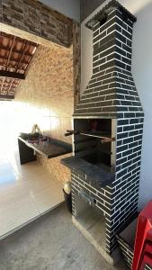 a brick oven in a kitchen with a counter at Casa de Férias á 400m pra Praia de Cabo Branco in João Pessoa