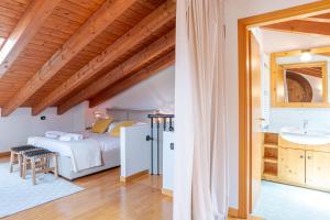 a bedroom with a bed and a sink in a room at Pearl Of The Lake apartment, Bellagio, breathtaking views and good vibes in Bellagio