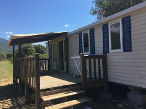 a tiny house with a porch and a deck at PROCHE du PONT GENOIS in Sartène