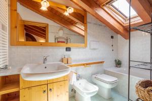 a bathroom with a sink and a toilet and a tub at Pearl Of The Lake apartment, Bellagio, breathtaking views and good vibes in Bellagio +44 photos