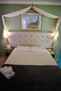 a bedroom with a large bed with a white headboard at Amoreira Pousada em Barra Grande Piaui in Barra Grande
