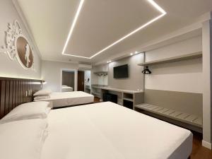 a bedroom with two beds and a tv in it at Fazzenda Park Resort in Gaspar +62 photos