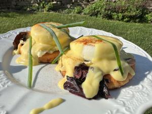 two sandwiches on a white plate with sauce at Garth Woodside Mansion Bed and Breakfast in Hannibal