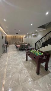 a room with a pool table and ping pong tables at درة العروس فيلا بشاطئ رملي خاص in Durat  Alarous