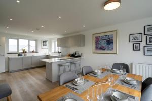 a kitchen and dining room with a table and chairs at Bay View Villa in Carbis Bay