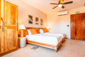 a bedroom with a bed and a ceiling fan at Bambuda Santa Catalina in Santa Catalina