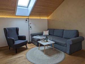 a living room with a couch and a chair and a table at Auszeit in Buch