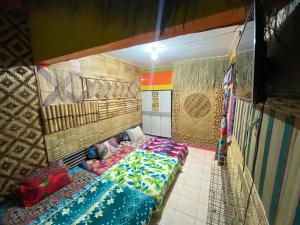 a room with a bed in the middle of a room at Pelemkecut Double-Degree Syariah Accommodation in Kejayan