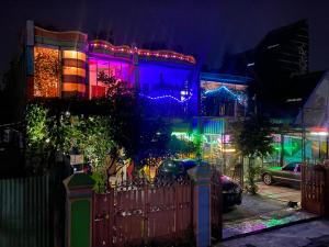 a house with christmas lights on it at night at Pelemkecut Double-Degree Syariah Accommodation in Kejayan