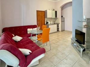 a living room with a red couch and a table at Boris Apartments in Petrovac na Moru