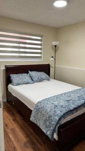 a bedroom with a bed and a window at Sabrina's Home in Delta