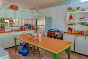 a kitchen with a table and a refrigerator at SMITH'S HOMESTAY in Georgetown