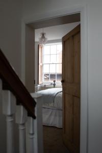 a bedroom with a bed and a large window at Chester Townhouse inside Roman Walls in Chester +49 photos