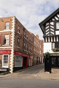 an empty street with brick buildings on a street at Chester Townhouse inside Roman Walls in Chester