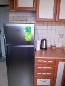 a kitchen with a refrigerator with a sticker on it at Apartament Wenecja in Toruń