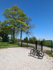 a bike parked next to a black fence at Ostoja Zielonki in Węgorzewo