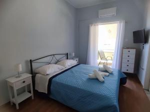 a bedroom with a bed with two pillows on it at magda's house in Galatas