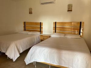 מיטה או מיטות בחדר ב-Hotel EL Porvenir