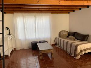 a bedroom with a bed and a table in it at La Arbolada in Puerto San Julian