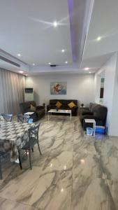 a large living room with couches and a table at درة العروس فيلا الذهبي 38 in Durat  Alarous