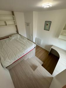 a small room with a bed and shelves in it at Face à la mer avec clim, wifi, parking in Le Barcarès