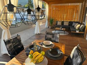 a living room with a table with a bowl of fruit at Ayana Mobile Home in Orebić