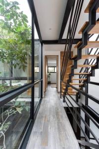 a hallway of a house with a wooden staircase at Chic Townhouse With Private Pool And Rooftop View in Tulum