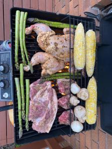 a grill with different types of meat and vegetables at Private Room- Shediac Beach House in Shediac