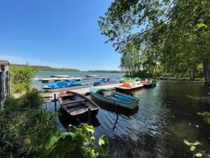 a group of boats are docked on a river at Glamping Zelt in Templin