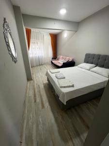 a bedroom with a large bed and a couch at Red sophia suites in Istanbul