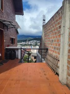 a balcony of a brick building with a view at Adelita Departamento in Loja