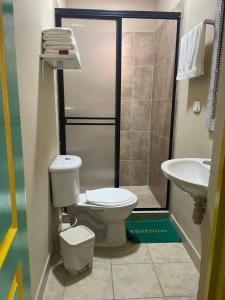 a bathroom with a toilet and a sink at LA ESTIBA HOTEL in Salento