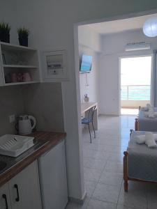 a kitchen and living room with a view of the ocean at NaDim rooms in Himare