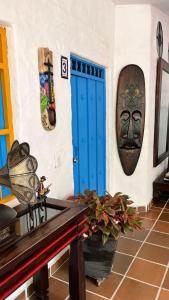 a room with a blue door and a mask on the wall at Hotel Casa Oliveros in Rivera