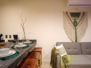 a dining room with a table and a couch at Akua Tulum Mexico in Tulum