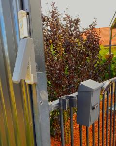 a security camera on the side of a fence at Red Cottage. 2 ROOM FOR 1. BEDROOM+Private Kithenette, Lounge, TV, Fridge room in Harristown