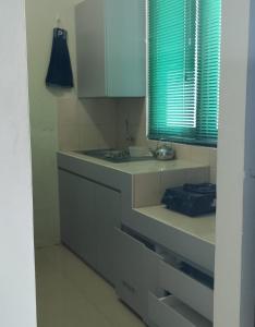 a kitchen with a counter and a sink and a window at Gated 3BR Residence - 10 mins from Malioboro in Yogyakarta