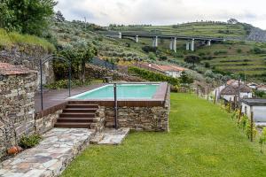 a house with a swimming pool in a yard at Casa dos Bardos in Alvações do Corgo