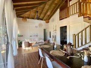 a living room with a table and chairs and a couch at HOLBOX PUERTA DEL MAR in Holbox Island
