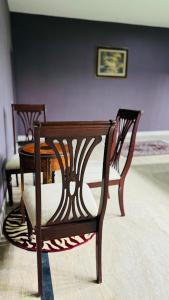 two chairs and a table in a room at Luxury Farmhouse for Stay and Events in Lahore