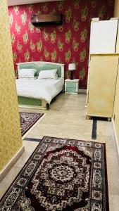 a bedroom with a bed and a rug at Luxury Farmhouse for Stay and Events in Lahore