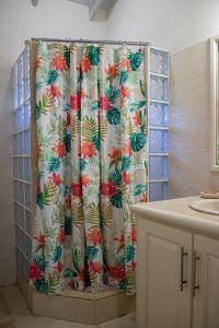 a shower curtain with a floral pattern in a bathroom at Best E Villas Providence Ch Ch in Christ Church