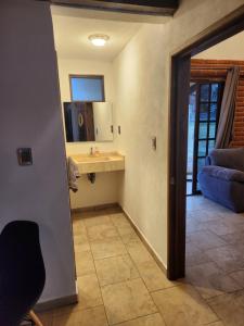 a bathroom with a sink and a mirror at Villa Nidawi by Natut Huasca in Huasca de Ocampo