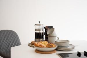 a table with a coffee maker and a bowl of food at Northern Hideaways, Lockup Mews in Bellingham +16 photos