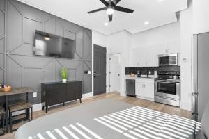 a kitchen with white cabinets and a ceiling fan at Columbus in Tampa