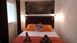 Un pat sau paturi într-o cameră la Cusco Plaza Hotel