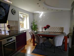 a kitchen and dining room with a table and chairs at Bergen Sunrise Terrace Apartment in Bergen