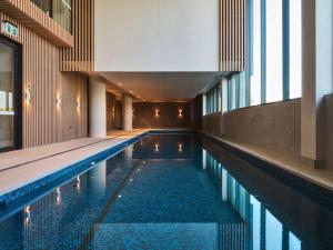 a swimming pool in the middle of a building at Novotel Melbourne Airport in Melbourne