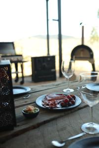 a wooden table with a plate of food and wine glasses at Residencia Artistica CasaVino in Casablanca +20 photos
