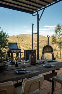 a wooden table with wine glasses and a grill at Residencia Artistica CasaVino in Casablanca